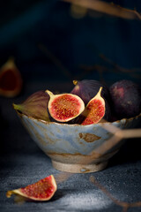 fresh figs in a beautiful plate on old blue concrete table, vertical