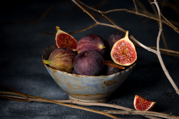 fresh figs in a beautiful plate on old blue concrete table, vertical