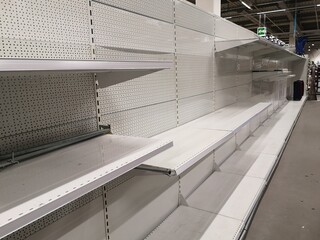 Empty white metal shelves in shop 