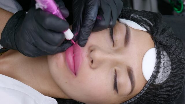 Microblading lip tattoo with special coloring pigment that corrects lip color in cosmetology clinic