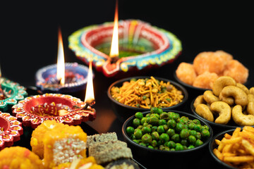 Salted Crispy Masala Namkeen Snacks And Sweet Mithai And Diya Deep Or Dia Illuminated. Theme For Navratri Pooja, Dussehra Puja, Deepawali Or Shubh Deepavali