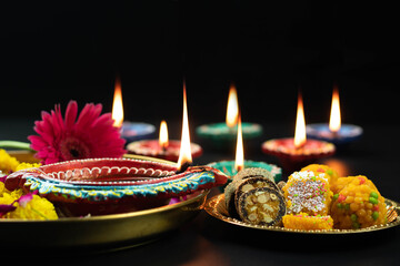 Big Clay Diya Deep Lit With Indian Mithai Laddu, Meetha Laddoo, Burfi, Anjeer Roll, Red Flower And...