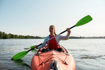 Resting family floats on canoe boat in lake