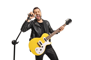 Male singer with a microphone and an electric guitar singing loud