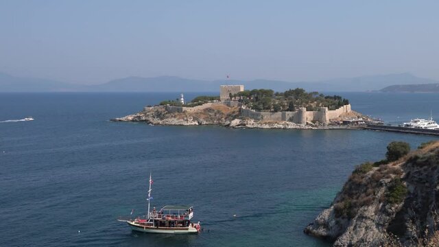 Kusadasi, Turkey - August 23, 2021: Pigeon Island Castle, (Guvercinada kalesi in Turkish) is a tourist attraction.