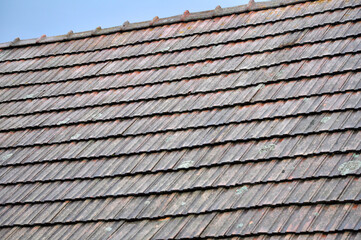 On the roof of the house is an old red tile