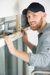 happy handy man climbing on a ladder