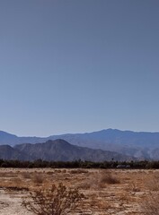 Deseet landscape with mountain background and clear blue skies 