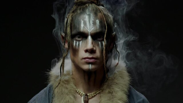 Elf wizard with pattern on face and white smoke around head