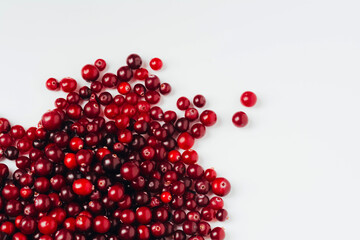 Close-up of a red ripe cranberry on a white background. Berry as an ingredient and source of vitamins, healthy food. Top view, copy space