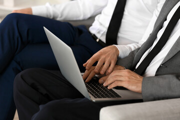 Boss seducing male worker in office. Concept of harassment