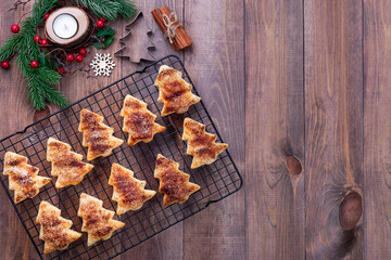 Christmas puff pastry cookies with sugar and cinnamon on a cooling rack