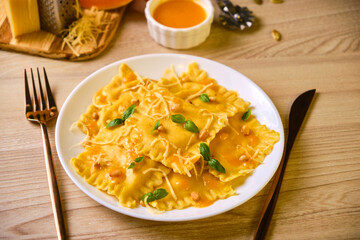 Homemade Pumpkin Ravioli with ricotta cheese served basil