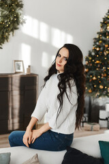 Fototapeta premium Beautiful young woman posing in the interior decorated for New year
