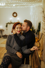 Couple in love photographed in a modern decorated Christmas-themed studio. Non-commercial appearance and neutral colors
