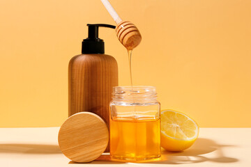 Composition with cosmetic products, honey and lemon on color background