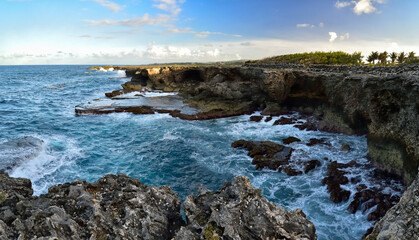 Fototapeta na wymiar Rough ocean waves crashing against the rocky cliffs of North Point, Barbados, Caribbean