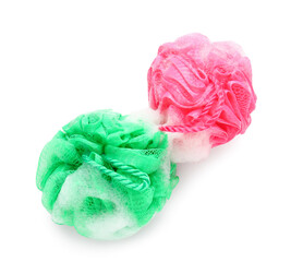 Soft bath sponges with foam on white background