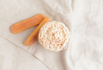 Glass of tasty Tiramisu Latte on light background