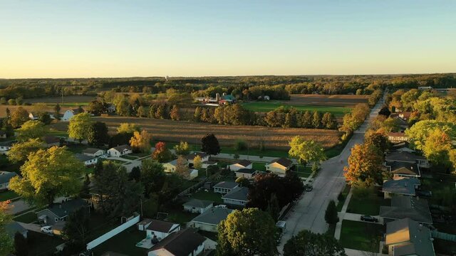 Sunset Autumn Rural Neighborhood And Farm House Scene With  Colorful Trees, Aerial Drone Shot. Midwest USA