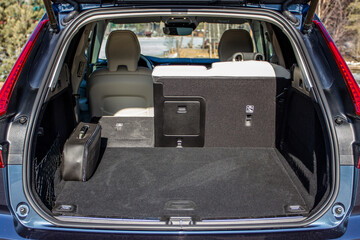 Huge, clean and empty car trunk in interior of a modern compact suv. Rear view of a SUV car with open trunk. Car trunk interior. - obrazy, fototapety, plakaty