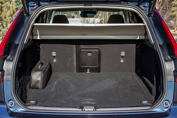 Huge, clean and empty car trunk in interior of a modern compact suv. Rear view of a SUV car with...