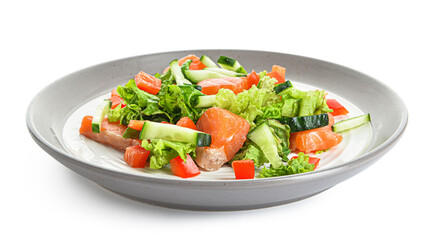 Tasty salad with salmon and vegetables in plate on white background