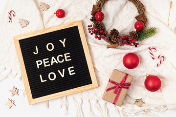 Felt letter board with text joy, peace, love and christmas gifts,  decoration. Winter holidays celebration concept. Flat lay, top view