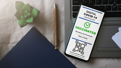 Valid digital COVID certificate on mobile device for verification. Green pass certificate for coronavirus vaccinations. Passport app in mobile phone. Coronavirus QR code scanning application.