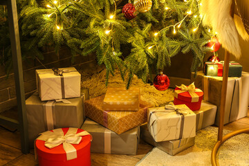 Fototapeta na wymiar Many gifts under Christmas tree on floor