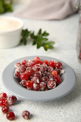 Plate with tasty sugared cranberries on white background