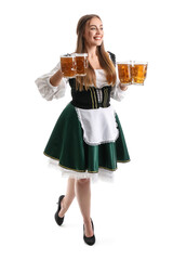 Beautiful Octoberfest waitress with pale beer on white background
