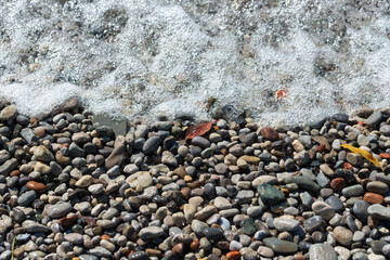 water rushing over pebbles on the beach