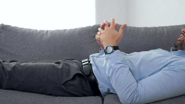 Sad adult bearded man with mental health problems after coronavirus lying on couch talking to psychologist. Doctor psychotherapist listens patient at psychotherapy session in medical clinic hospital