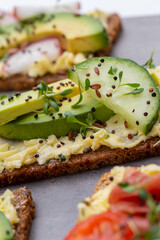 Sandwiches with cream cheese, vegetables and salami.