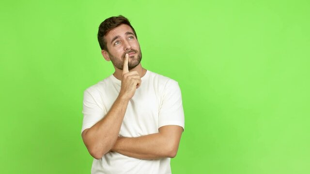 Handsome man standing and thinking an idea pointing the finger up over isolated background