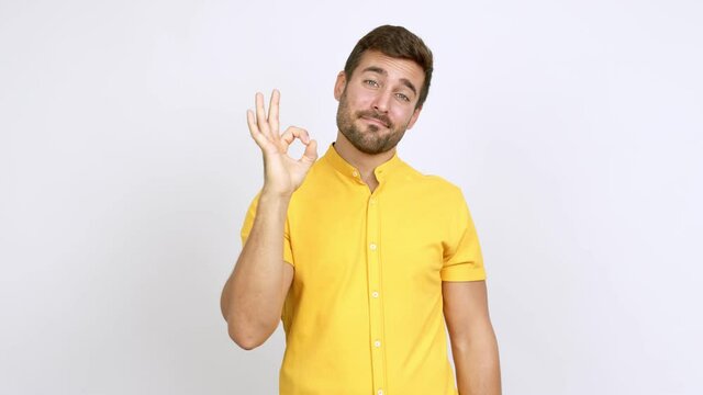 Handsome man showing ok sign with fingers over isolated background