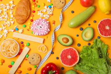 healthy foods and unhealthy foods on a colored background close-up top view.