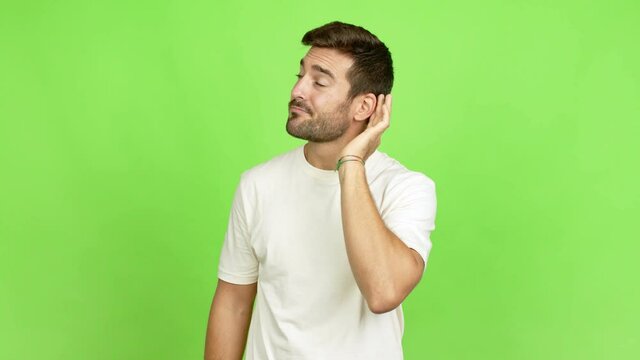 Handsome man listening something over isolated background