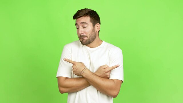 Handsome man pointing to the laterals having doubts over isolated background
