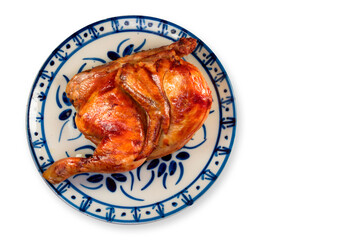Half roast chicken on plate and white background.