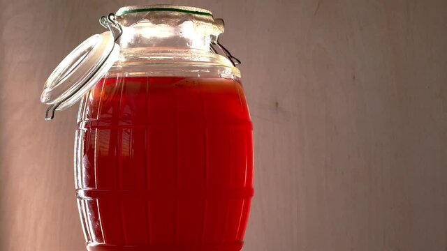 Glass jars with kombucha fermented beverage rotating. Alternative medicine concept.