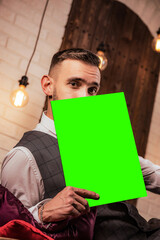 a man in a formal suit with a tablet and a book in his hands