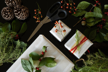 Christmas gifts decorated with natural Christmas plants