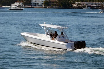 Open sport fishing boat with a covered center console.