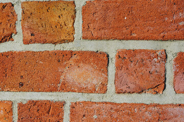 Close up of textured red brick wall background or backdrop, rectangular red terracotta bricks laid out as pattern, architectural structure for old rough building