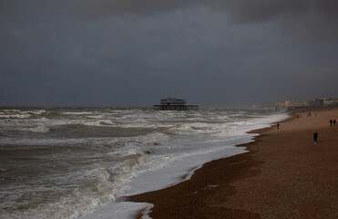 The old pier in a storm at Brighton seafront, United Kingdom