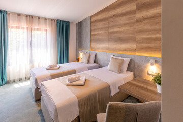Interior of a double bed hotel bedroom in modern luxury hotel in the morning