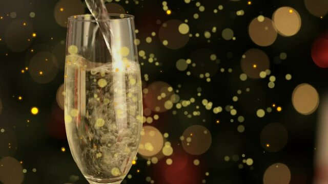 Animation of golden lights over champagne pouring into glass