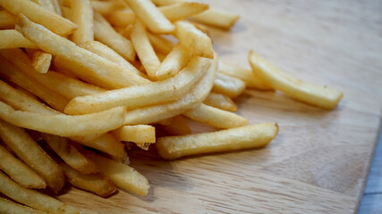 木製のボードに盛り付けられたファストフードのフライドポテト